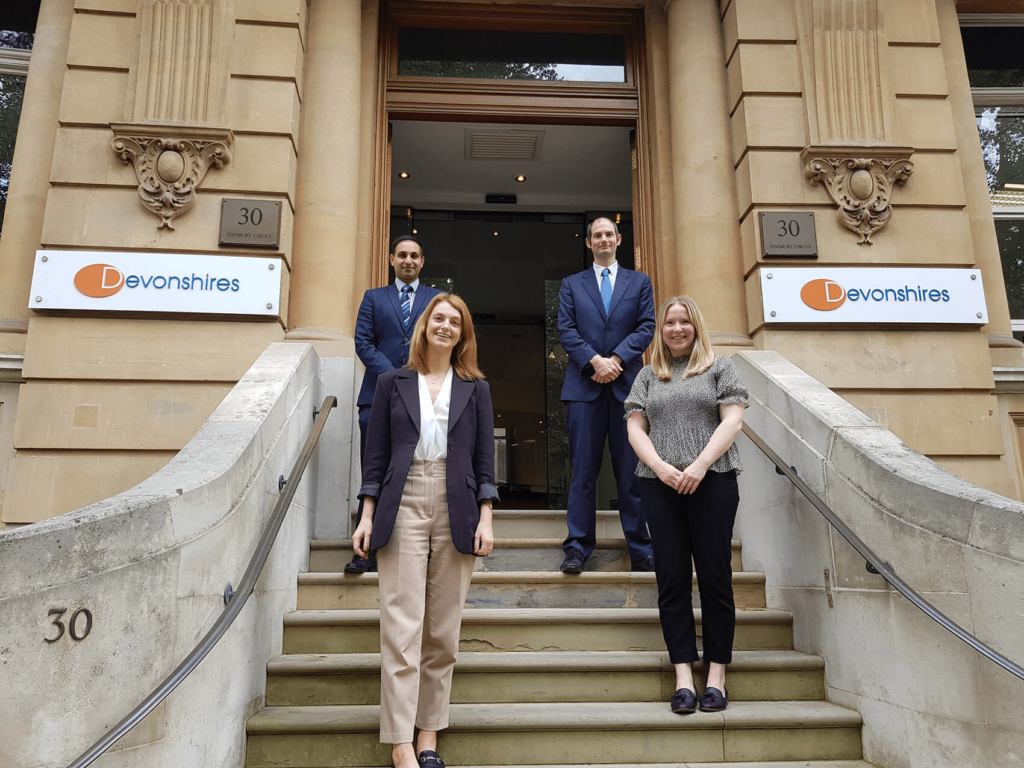 New joiners standing outside Devonshires offices